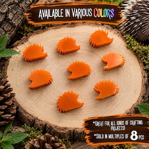 May include: Seven small, orange, hedgehog-shaped flat ornaments. The text at the top reads AVAILABLE IN VARIOUS COLORS. The text at the bottom reads *GREAT FOR ALL KINDS OF CRAFTING PROJECTS! *SOLD IN MULTIPLES OF 8 PCS.
