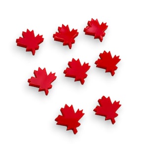 May include: Seven red maple leaf shaped decorations on a white background.