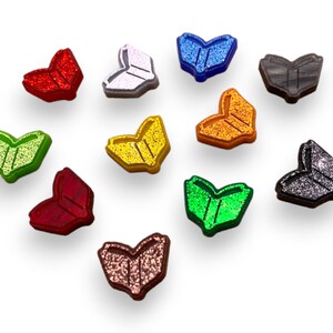 May include: Twelve heart-shaped book charms with glitter finishes in various colors, including red, white, blue, gray, green, yellow, and orange.