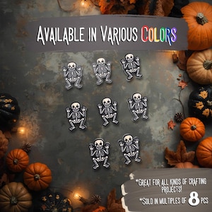 May include: A collection of eight skeleton-shaped craft embellishments, each with a white skeleton design on a black background. The image includes text that reads "AVAILABLE IN VARIOUS COLORS" and "GREAT FOR ALL KINDS OF CRAFTING PROJECTS!"
