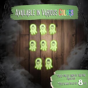May include: Eight neon green ghost-shaped craft pieces with smiling faces are displayed against a wooden background. The text "AVAILABLE IN VARIOUS COLORS" is at the top. The text "GREAT FOR ALL KINDS OF CRAFTING PROJECTS!" and "SOLD IN MULTIPLES OF 8 PCS" are at the bottom.