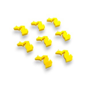 May include: Eight yellow Michigan state outline shapes on a white background.
