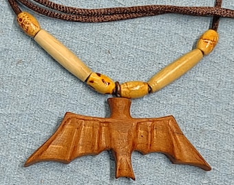 item 915 - Cherry wood bat pendant on adjustable coffee color silk cord