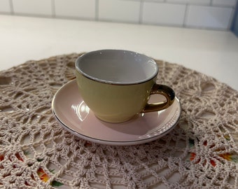Small pink yellow and gold cup and saucer