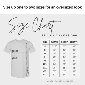 May include: A white t-shirt with a size chart, including width, chest, and length measurements in inches. The chart lists sizes from XS to 5XL. The text "Size Chart" is displayed in a cursive font.