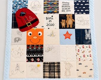 May include: A patchwork baby quilt with a light blue border. The quilt features various fabric squares with images of cars, elephants, bears, and a pumpkin face. A red bib with a Santa design is on top. The quilt also has the text "Born in 2020".