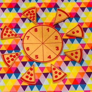 May include: A felt pizza game with eight slices and a centre circle numbered 1 through 8. The slices are beige with red pepperoni and the centre circle is beige with red numbers.