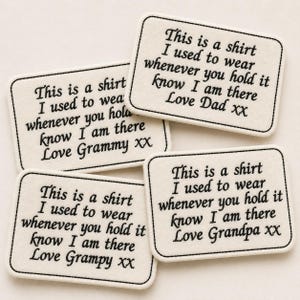 May include: Four rectangular patches with rounded corners, each embroidered with a message in black thread. The text reads, "This is a shirt I used to wear whenever you hold it know I am there Love [Family Member] XX."