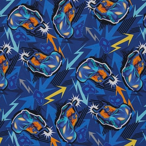 May include: A blue and orange repeating pattern featuring a cartoon character driving a car. The character is wearing a blue mask and a red cape. The background is a blue and yellow pattern.