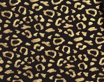 Stretch jersey cotton Leo Leo pattern gold metallic on black