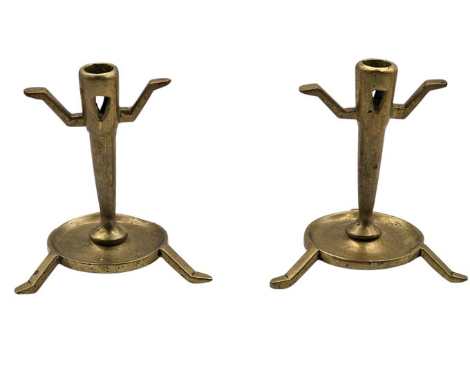 Pair of antique bronze or copper candlesticks, anthropomorphic
