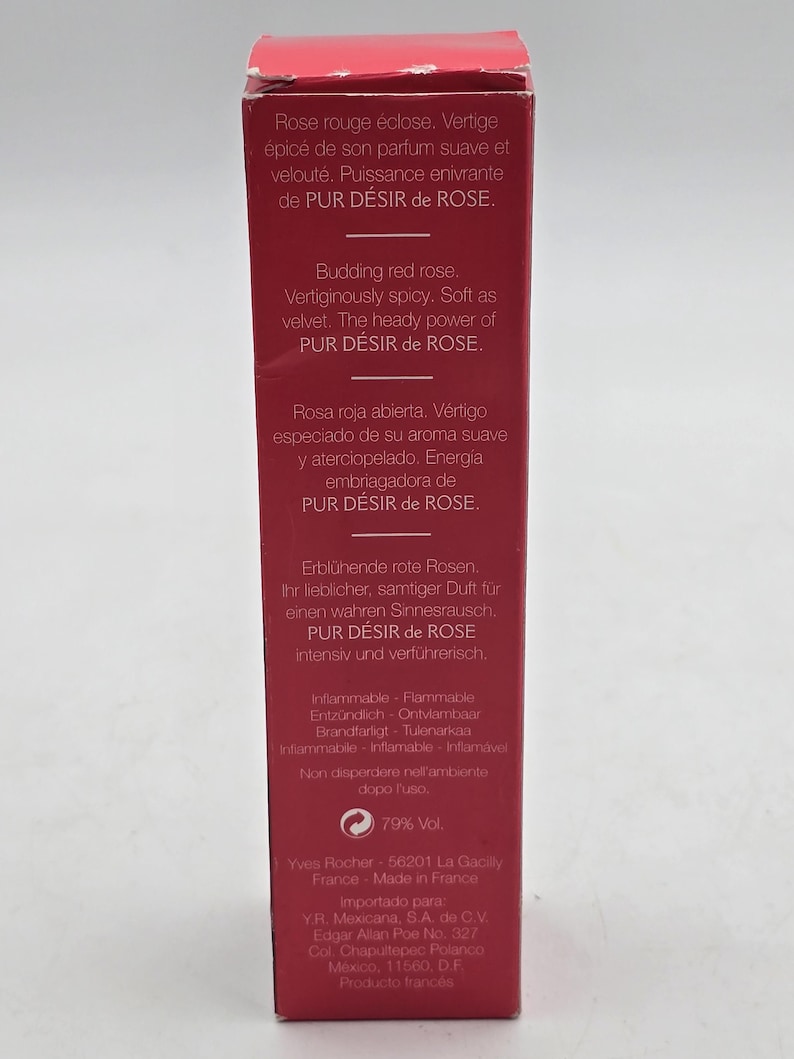 May include: A red rectangular box with text in multiple languages, including English, French, German, and Spanish. The text describes a fragrance called "PUR D&Eacute;SIR de ROSE" and includes the phrase "Budding red rose."