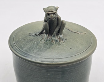 Ceramic lidded jar with devil monkey decoration