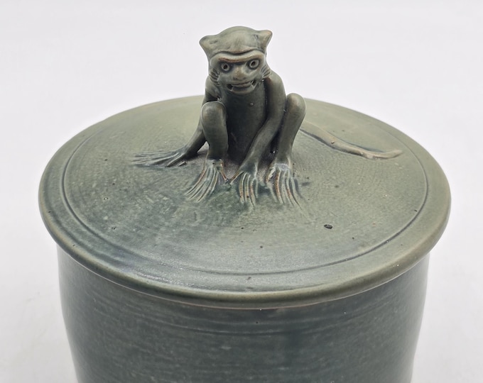 Ceramic lidded jar with devil monkey decoration