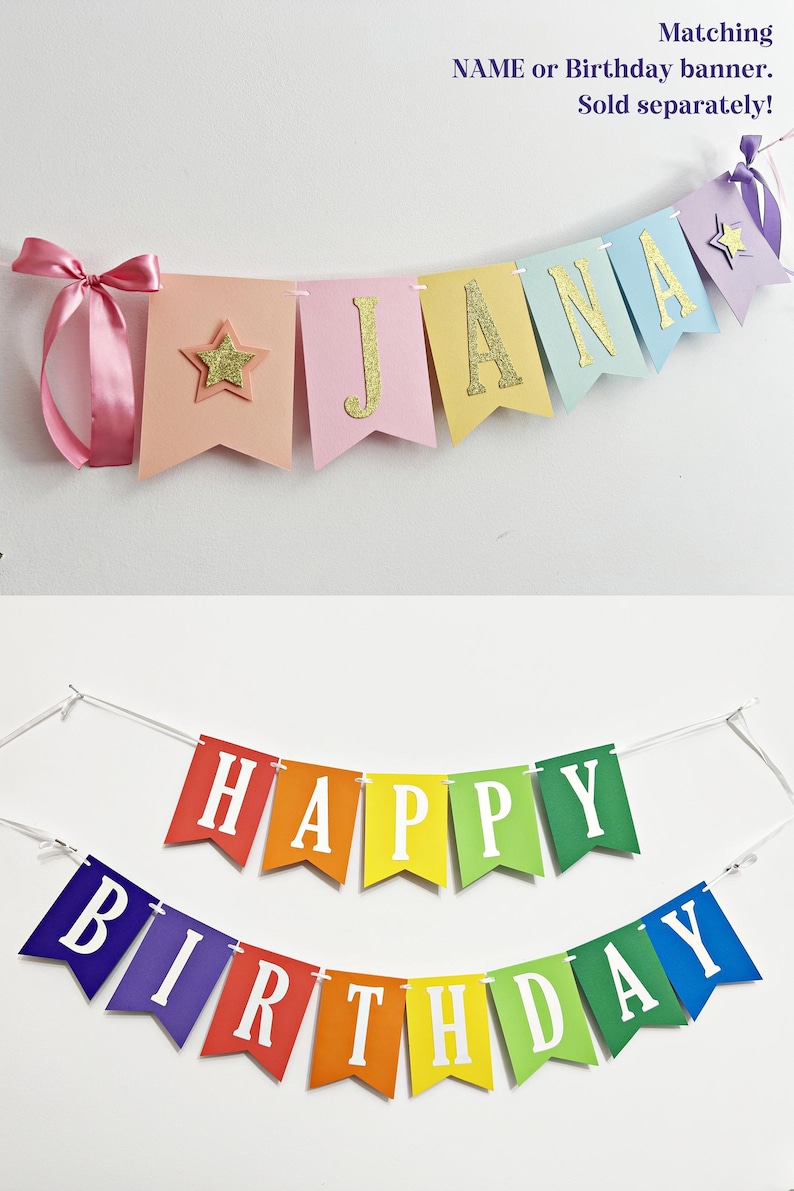 May include: A pastel-colored banner spelling JANA with gold glitter letters and stars, tied with pink ribbon, and a separate rainbow-colored banner with white letters spelling HAPPY BIRTHDAY, both featuring swallowtail pennant flags on white string.