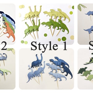 May include: Three sets of dinosaur cupcake toppers in different styles. The first set is green and yellow, the second set is blue and green, and the third set is green, blue, and gold. Each set has a variety of dinosaur shapes and sizes.