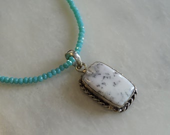 Dendritic White Agate pendant on a light blue beaded crystal chain.