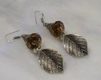 Leaf earrings on a brown bead.