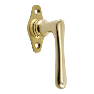 May include: A polished brass window handle with a curved lever and a rectangular base plate with two mounting holes.