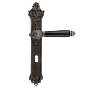 May include: Ornate, antique-style door handle with a dark, weathered finish. The handle features intricate floral and scrollwork details, a black grip, and a keyhole. The design suggests a vintage or historical aesthetic, suitable for interior doors.