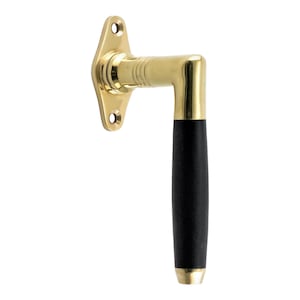 May include: A brass door handle with a black wooden grip. The handle is attached to a brass plate with two holes for screws.