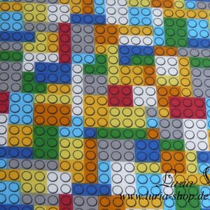 Puede incluir: Una tela colorida con un patr&oacute;n repetitivo de cuadrados y c&iacute;rculos, que se asemeja a bloques de construcci&oacute;n. La tela es una mezcla de amarillo, naranja, rojo, verde, azul, gris y blanco.