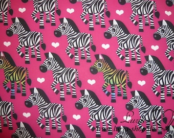 May include: Pink fabric with a repeating pattern of black and white cartoon zebras with white hearts. The zebras have rainbow stripes.