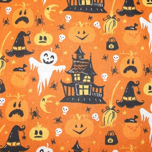 May include: Orange fabric with a Halloween pattern featuring black silhouettes of houses, ghosts, pumpkins, witches' hats, and bats. The background is a solid orange colour.