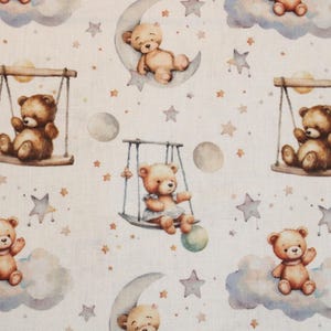 May include: A white fabric with a repeating pattern of brown teddy bears, stars, moons, and clouds. The bears are depicted in various poses, including swinging on swings, sleeping on moons, and sitting on clouds.