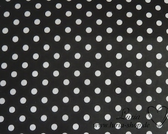 May include: Black fabric with white polka dots. The fabric has a subtle sheen. The text "Luria www.luria-shop.de" is in the bottom right corner of the image.