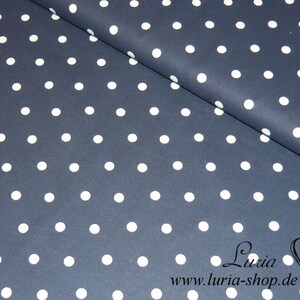 May include: Navy blue fabric with a white polka dot pattern. The fabric is folded in half, showing the pattern on both sides.