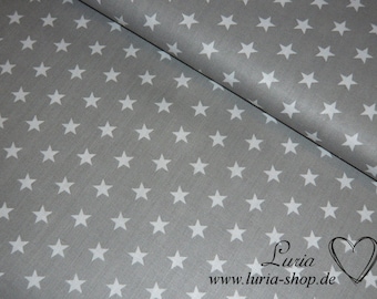 May include: Gray fabric with a white star pattern. The fabric is folded in half, showing the pattern on both sides. The fabric is smooth and has a slight sheen.