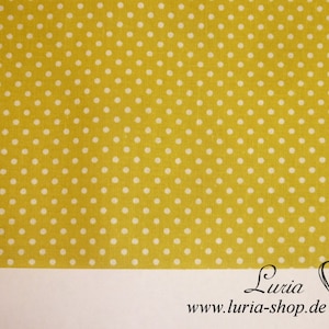 May include: Yellow fabric with a white polka dot pattern.