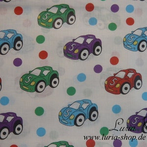 May include: White fabric with a repeating pattern of colourful toy cars and polka dots. The cars are all facing right and have the number 5 on them. The polka dots are in various colours, including red, blue, green, and purple.