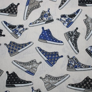 May include: A white fabric with a repeating pattern of blue and gray high-top sneakers. The sneakers have different designs, including polka dots, hearts, and floral patterns.