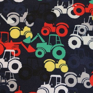 May include: A navy blue fabric with a repeating pattern of white, red, green, and yellow tractors. The tractors are all different sizes and shapes, and some have scoops or other attachments.