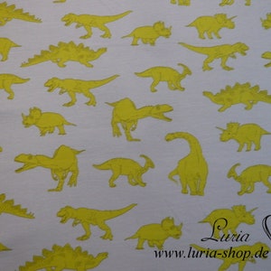 May include: White fabric with a repeating pattern of yellow dinosaurs. The dinosaurs are in various poses, including walking, running, and standing. The fabric has a subtle texture.