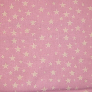May include: Pink fabric with a white star pattern. The stars are of varying sizes and are scattered randomly across the fabric.