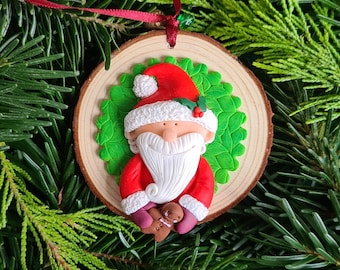 Ornament - Santa Claus with gingerbread - modeled on a wooden disc