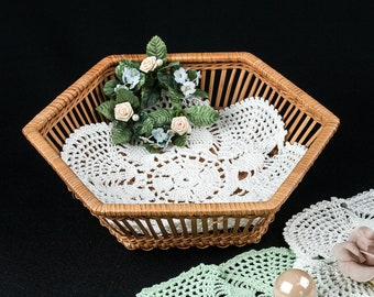 Small basket made of natural material, set with crochet doilies, vintage decoration from the 50s, retro living style.