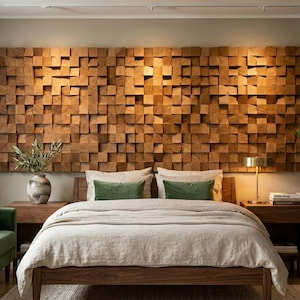 May include: A bedroom with a striking wooden headboard made of small, square blocks. The bed has a wooden frame and is covered with a neutral-toned duvet. Green cushions and a green sofa provide colour. A potted plant and a lamp are also present.