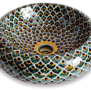 May include: Oval ceramic sink with a decorative pattern. The sink features a repeating design of green, yellow, and blue shapes on a gray background. The center has a yellow floral design around the drain.