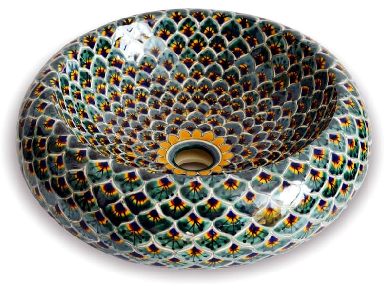 May include: Oval ceramic sink with a decorative pattern. The sink features a repeating design of green, yellow, and blue shapes on a gray background. The center has a yellow floral design around the drain.
