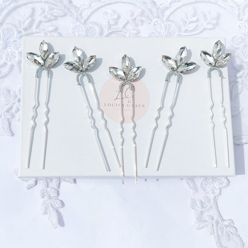 five large silver pins embellished with sparkly clear crystal marquise cut leaves with twisted wire stems,