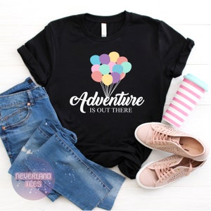 May include: Black t-shirt with a white graphic of colorful balloons and the text "Adventure is out there".