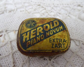 antique "Herald" piano needle box, filled