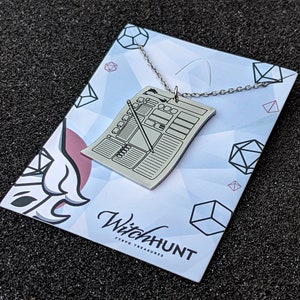 Silver character sheet necklace pendant on display card. Great Dungeons & Dragons necklace for TTRPG enthusiasts looking for distinctive character sheet jewelry.
