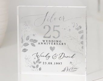 May include: Silver 25th wedding anniversary clear acrylic block with a floral design and the text "Silver 25 Wedding Anniversary Wendy & David 23.08.1997"