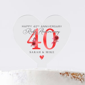 May include: A red heart-shaped acrylic cake topper with the text "Happy 40th Anniversary Ruby Anniversary 40 Sarah & Mike" and a small red heart at the bottom.