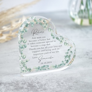 May include: A clear heart-shaped acrylic paperweight with a floral design and a personalised message. The message reads: "Any man can become a Father but it takes someone special to become a step-dad. Thank you for all your love and support and being such an important part of my life. Love, Samantha 28.10.2024"